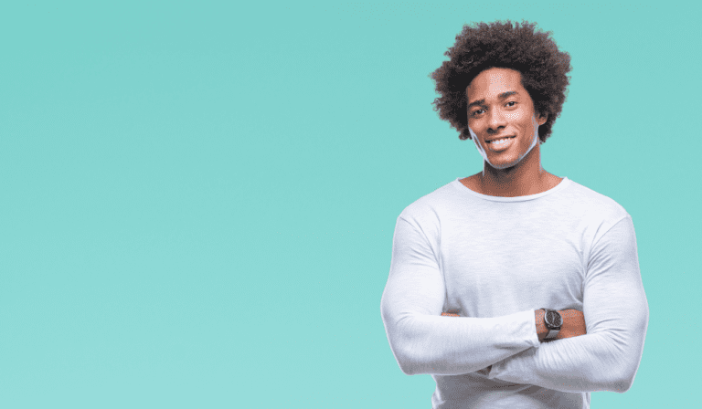 A man with curly hair is smiling for the camera.