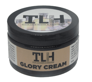 A jar of glory cream on top of a table.