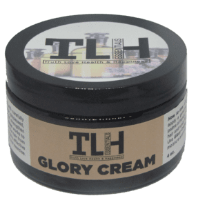 A jar of glory cream on top of a table.